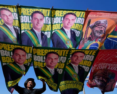 A street vendor sells campaign flags of presidential candidates Sen. Flavio Bolsonaro and current President Luiz Inacio Lula da Silva who is running for reelection in Brasilia, Brazil, Tuesday, Sept. 29, 2026. (AP Photo/Eraldo Peres)
