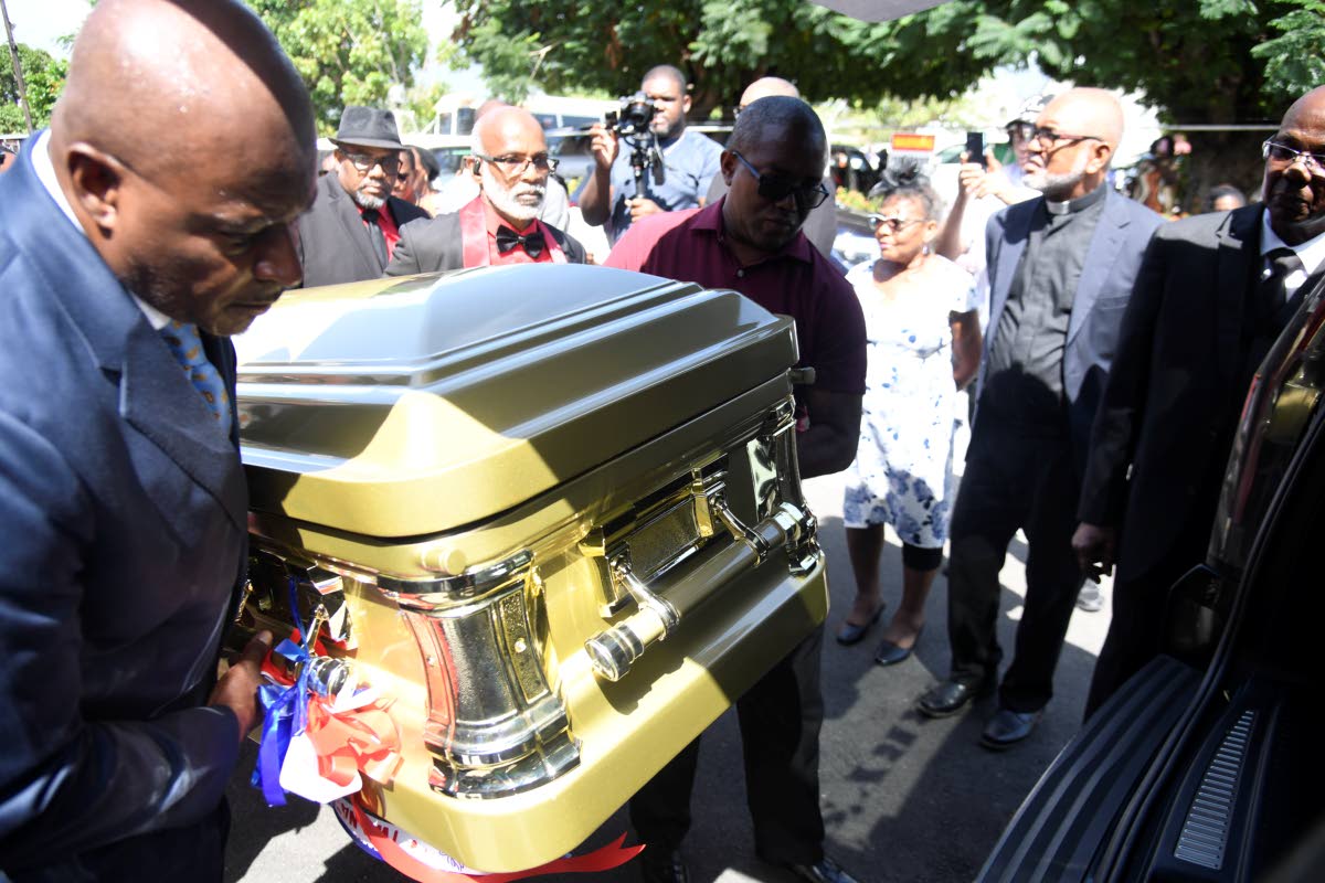 Pallbearers loading the coffin containing the remains of Dervan Malcolm ahead of transport to interment at the Family Plot in Wakefield, St Catherine.