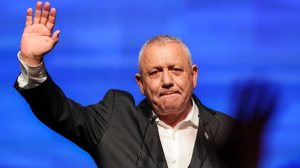 Gadi Eisenkot lifts his arm in the air as he addresses supporters