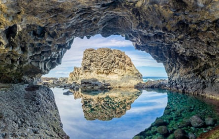 A natural pool surrounded by rocks next to the sea