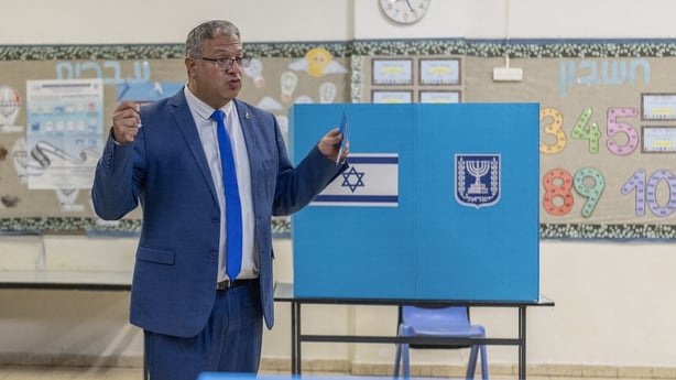 Itamar Ben Gvir gestures as he prepares to cast his ballot at a polling station