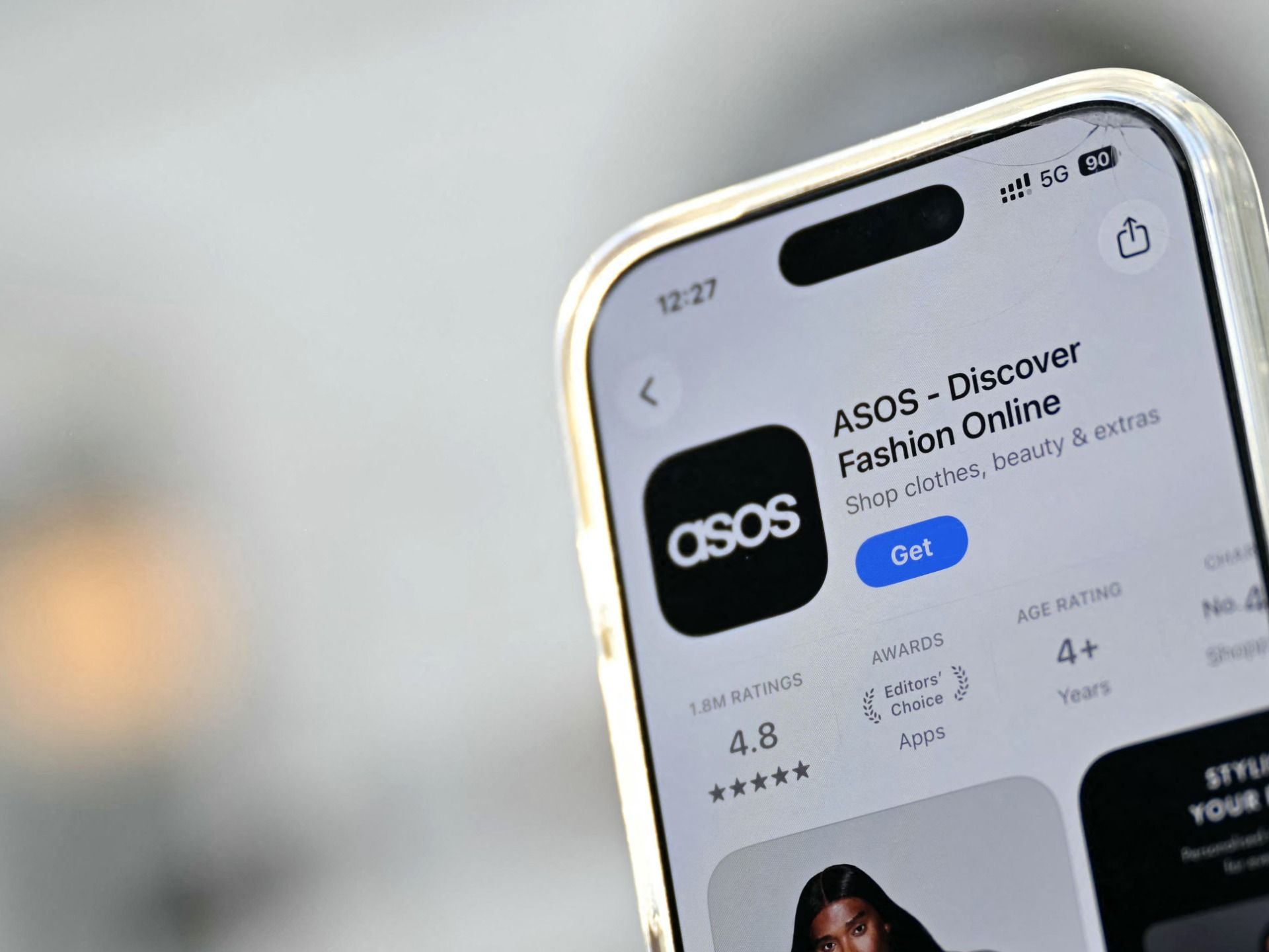 A phone showing the ASOS app download page